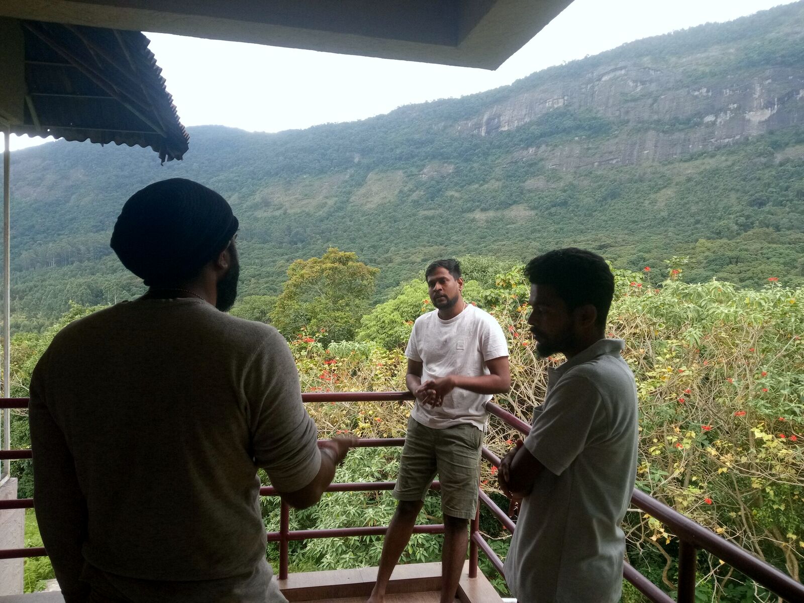 AyC Tribe members discussing strategy on a hill-facing balcony