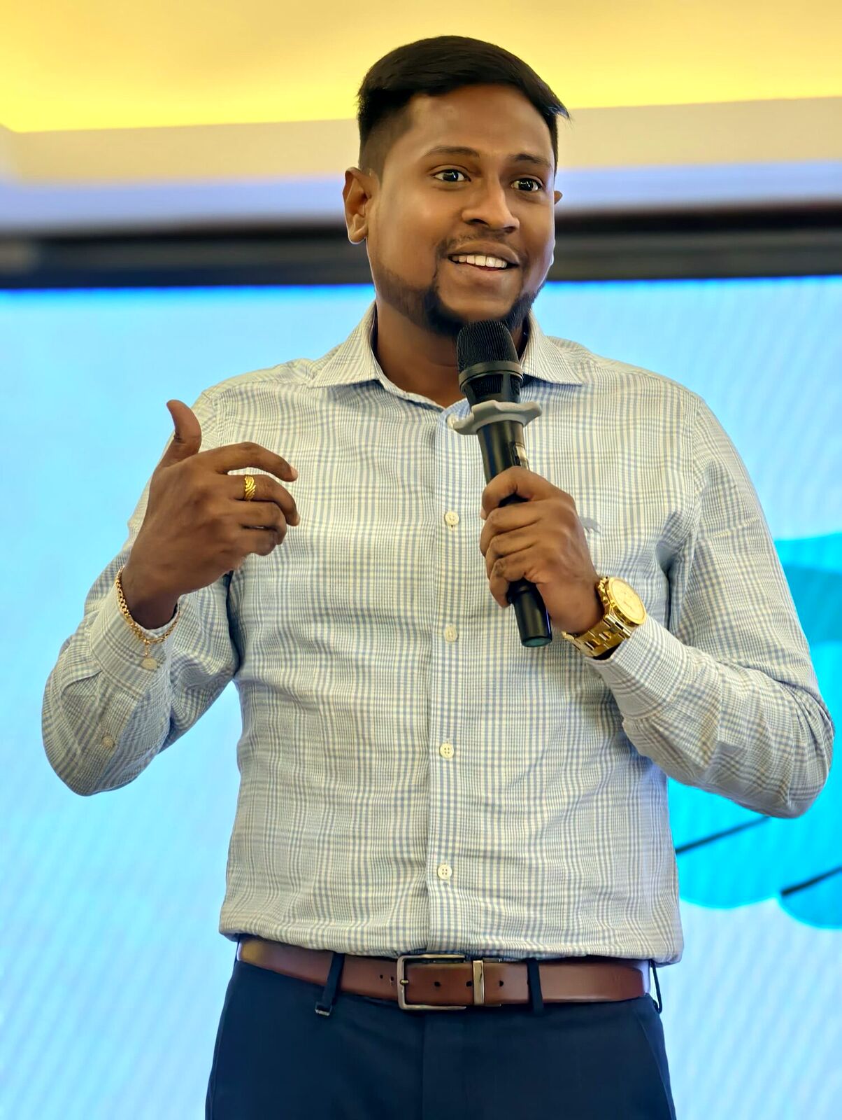 Our founder speaking on stage with a mic